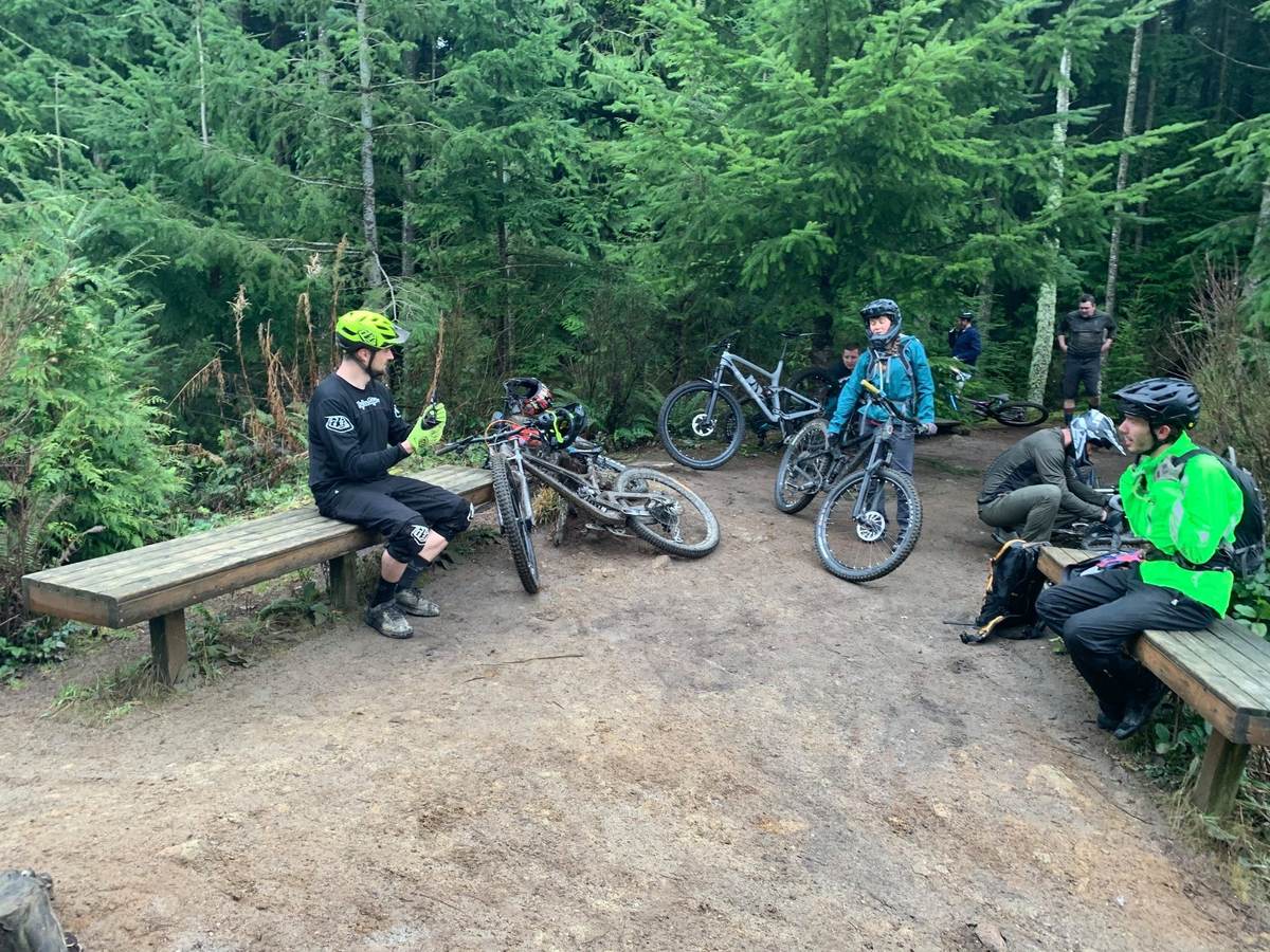 Riders and bikes gathered at the trailside benches