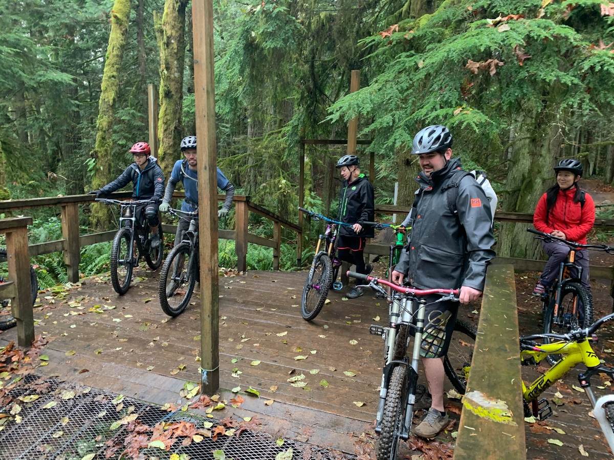 Group ride crew gathered on the wooden features at Duthie Hill