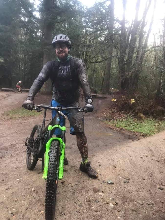 Muddy and smiling after a wet PNW lap