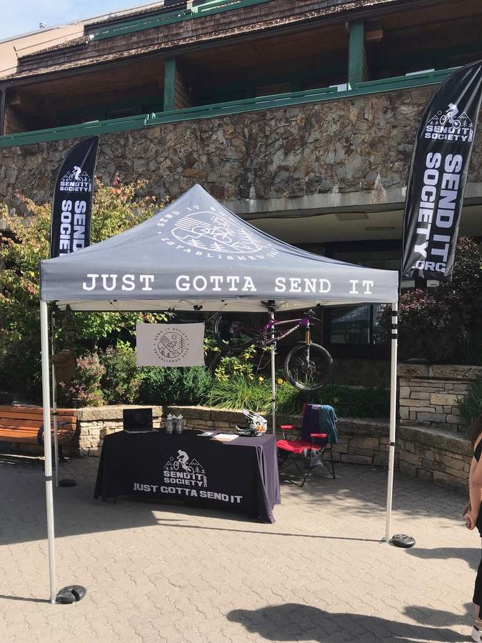 The Send It Society booth on the road